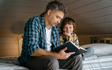 A person teaching a child from bible